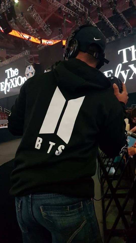 Fans are offended by a staff member who wore a BTS hoodie at EXO's
