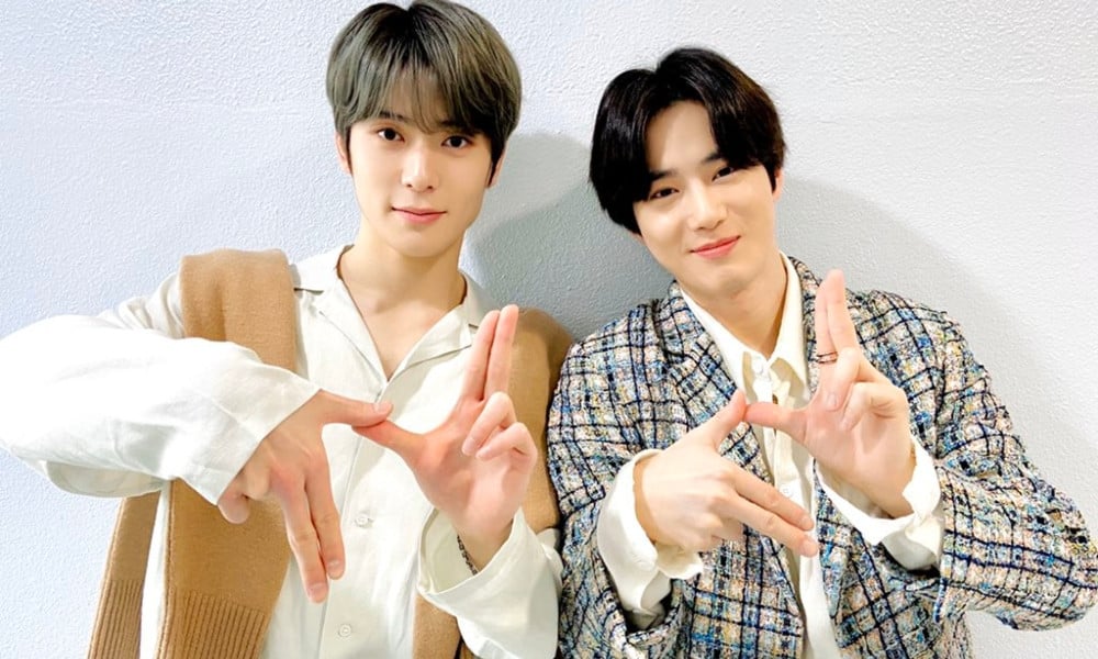 EXO's Suho playfully flashes 'NCT' hand sign alongside NCT's Jaehyun