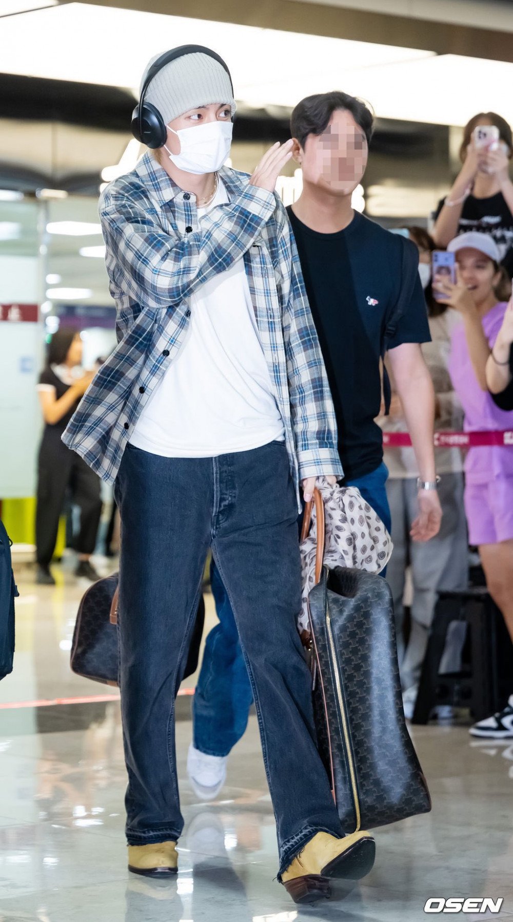 BTS's V (Kim Taehyung) turns heads at the airport with his